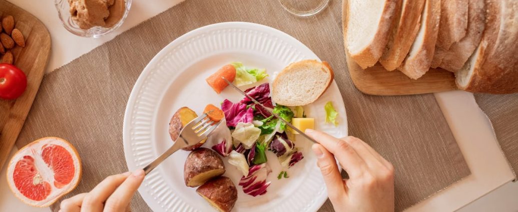 Top view of a nutritious breakfast setup with salad, bread, and fresh juice, perfect for a healthy start.